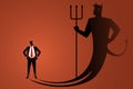 businessman standing with hands on waist facing his own evil shadow