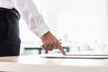 Businessman standing at his desk pointing to a document, application or contract holding a pen Royalty Free Stock Photo