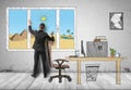 Businessman standing in his office in front of the window with pyramids and sands behind it