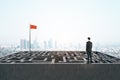 Businessman standing on labyrinth with red flag Royalty Free Stock Photo