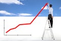 Businessman standing on ladder drawing global diagrams