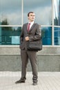 Businessman Standing with Laptop Bag Over Shoulder Royalty Free Stock Photo