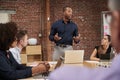 Businessman Standing And Leading Office Meeting Around Table Royalty Free Stock Photo