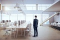 Businessman standing in modern coworking office interior Royalty Free Stock Photo