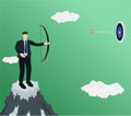 Businessman standing on mountain shooting target Royalty Free Stock Photo