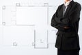 Businessman standing near a House blueprints