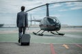 Businessman standing near private helicopter