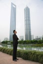 Businessman standing near skyscrapers Royalty Free Stock Photo