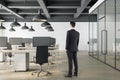 Businessman standing office interior with open space and computers Royalty Free Stock Photo