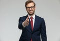 Businessman standing with one hand raised ready to shake hands Royalty Free Stock Photo