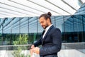 Businessman standing outdoor use smartphone