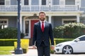 Businessman standing outside a modern house. Real estate concept. Agent ready to sell home. Royalty Free Stock Photo