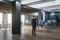 Businessman standing in panoramic open space modern office Royalty Free Stock Photo