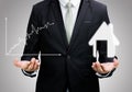 Businessman standing posture hand hold graph and house isolated Royalty Free Stock Photo