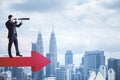 Businessman standing on red arrow and looking on city Royalty Free Stock Photo