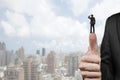 Businessman standing on top of another big thumb Royalty Free Stock Photo