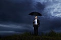 Businessman standing with umbrella Royalty Free Stock Photo