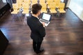 Businessman standing and using laptop in conference hall Royalty Free Stock Photo