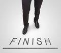 Businessman standing wearing court shoes on finish line. Royalty Free Stock Photo