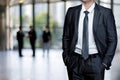 A businessman stands on the blurred background