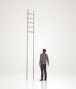 Businessman stands in front of the ladder without steps