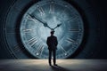 A man in a suit against the background of a dial, rear view. A businessman stands and looks at a large watch. Concept: time is Royalty Free Stock Photo