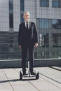 Businessman stands on a monowheel. Royalty Free Stock Photo