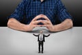 Businessman stands with raised hands in front of cropped portrait big man sitting Royalty Free Stock Photo