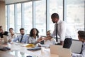 Businessman Stands To Address Meeting Around Board Table Royalty Free Stock Photo