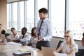 Businessman Stands To Address Meeting Around Board Table Royalty Free Stock Photo