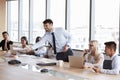 Businessman Stands To Address Meeting Around Board Table Royalty Free Stock Photo