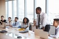 Businessman Stands To Address Meeting Around Board Table Royalty Free Stock Photo