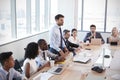 Businessman Stands To Address Meeting Around Board Table Royalty Free Stock Photo