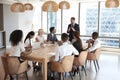 Businessman Stands To Address Meeting Around Board Table Royalty Free Stock Photo