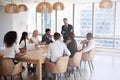 Businessman Stands To Address Meeting Around Board Table Royalty Free Stock Photo