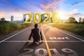 Businessman Starting to new year,The readiness of leaders, vision in the middle of empty asphalt road at golden sunset and Royalty Free Stock Photo