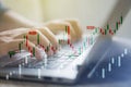 Businessman with statistic graph of stock market financial indices analysis on laptop screen.