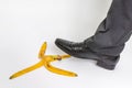 Businessman stepping on banana peel - business risk concept Royalty Free Stock Photo