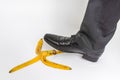 Businessman stepping on banana peel - business risk concept Royalty Free Stock Photo