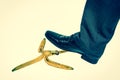 Businessman stepping on banana peel - retro style Royalty Free Stock Photo