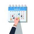 Businessman sticking push pin into month schedule