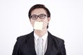 Businessman with sticky note on his mouth Royalty Free Stock Photo
