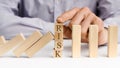 Businessman stop domino effect with word Risk