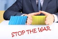 Businessman Stopping The Effect Of Domino With Hand At Desk. Stop War Royalty Free Stock Photo