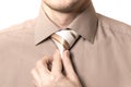 Businessman straightens his tie closeup on white background