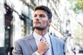 Businessman straightens his tie