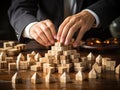 Businessman strategically assembling wooden blocks