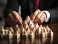 Businessman strategically assembling wooden blocks