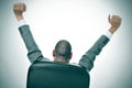 Businessman stretching in his office chair