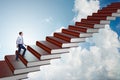 The businessman student climbing the ladder of education books Royalty Free Stock Photo